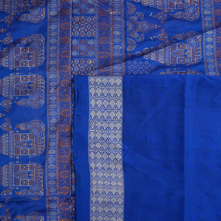 Close-up of Bomkai Silk Saree fabric texture and handloom weave in orange and blue threads.