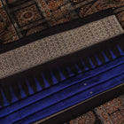Close-up of the intricate woven texture of blue and black Bomkai silk saree with butta.