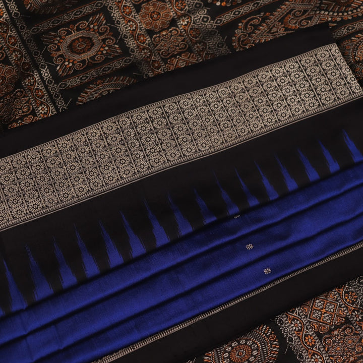 Close-up of the intricate woven texture of blue and black Bomkai silk saree with butta.