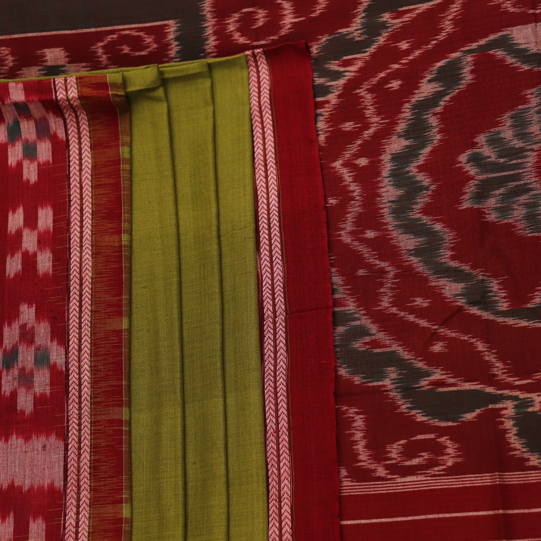 Green and maroon cotton Sambalpuri saree draped on a model, showcasing the Pasapalli pattern.