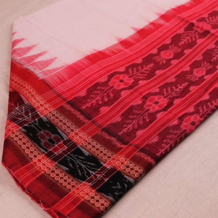 A woman wearing a white and red Sambalpuri cotton dupatta with a plain pattern, draped over her shoulder