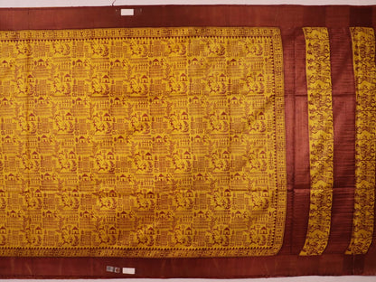 Close-up showing the textured weave of a yellow and brown printed Tussar silk saree.
