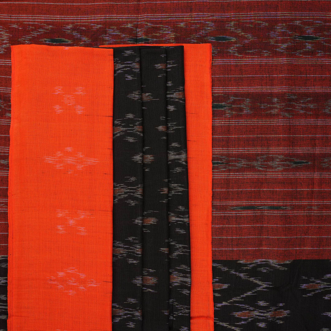 Elegant model styling of a black and orange Sambalpuri cotton saree showcasing the complete handloom look.