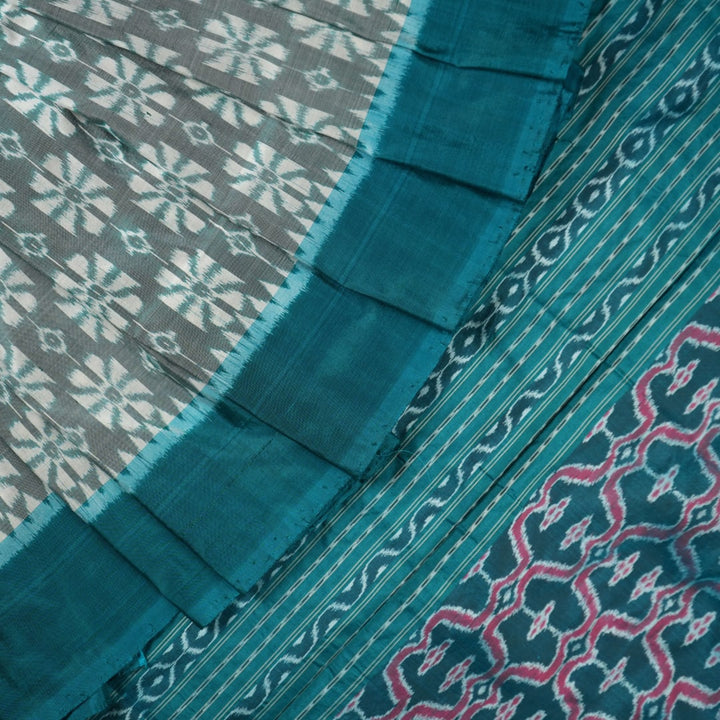 Close-up revealing the luxurious silk texture and subtle motif weave of the blue Sambalpuri saree.