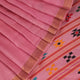 Close-up view of the smooth, textured tussar silk fabric in a delicate pink hue, showcasing the intricate butta pattern.