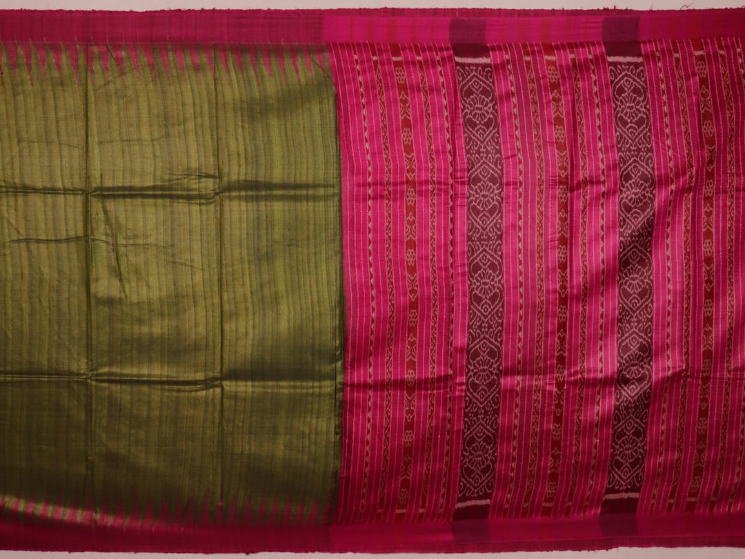 Close-up view of the luxurious texture of a plain green Tussar silk saree with a magenta border