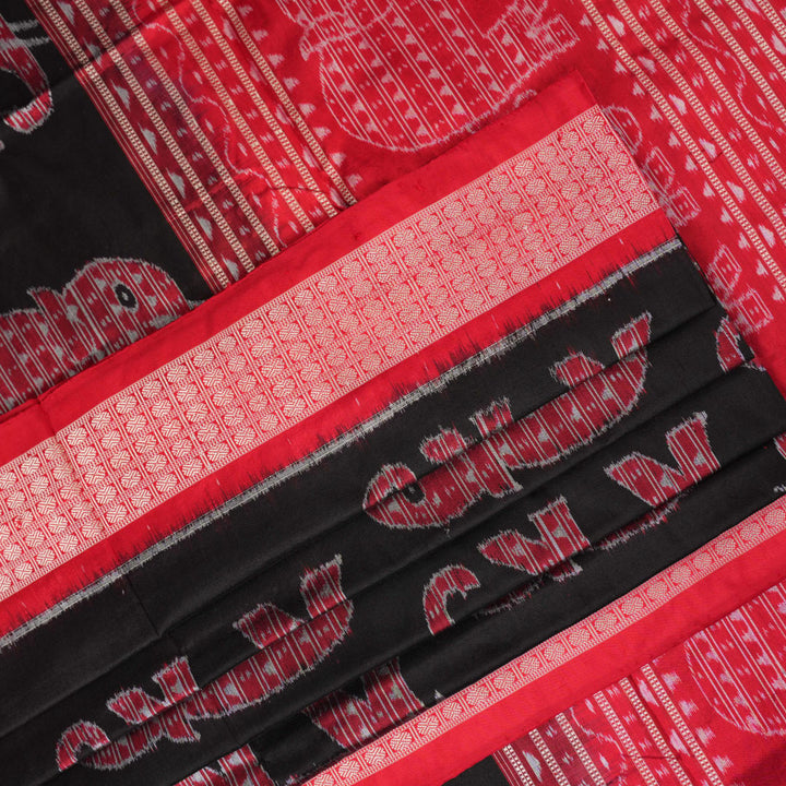 Close-up showing the luxurious texture and fine weave of the black Sambalpuri silk fabric.