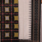 Detail of the black and white Sambalpuri cotton dress material's blouse piece with motifs.