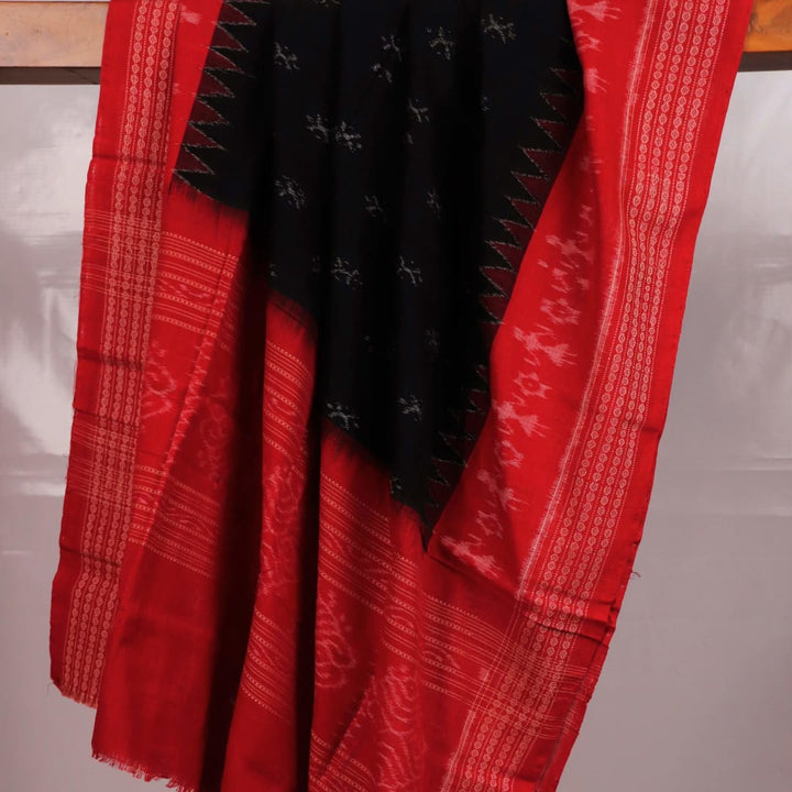 Close-up of a lightweight, black cotton Sambalpuri dupatta with red motifs in the border