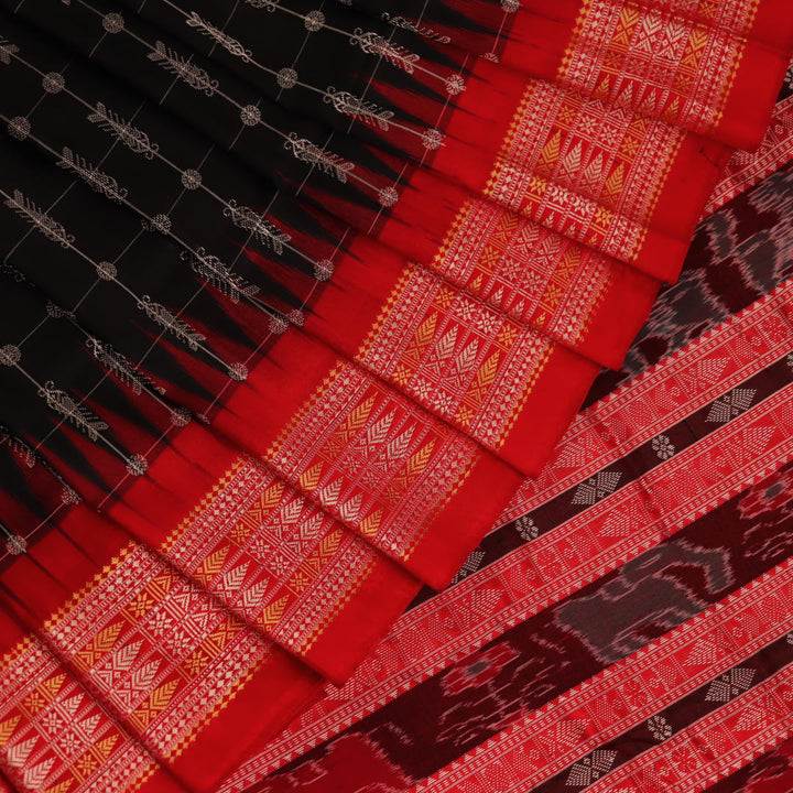 Close-up of black and red silk fabric texture with butta pattern.