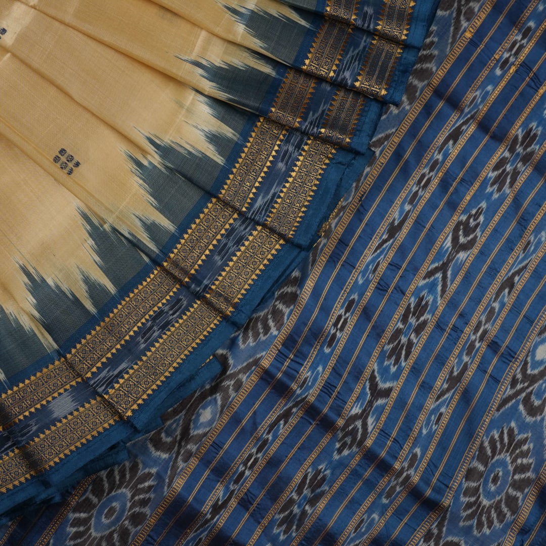 Elegant styling of cream and blue Khandua silk saree with butta pattern on model for traditional look