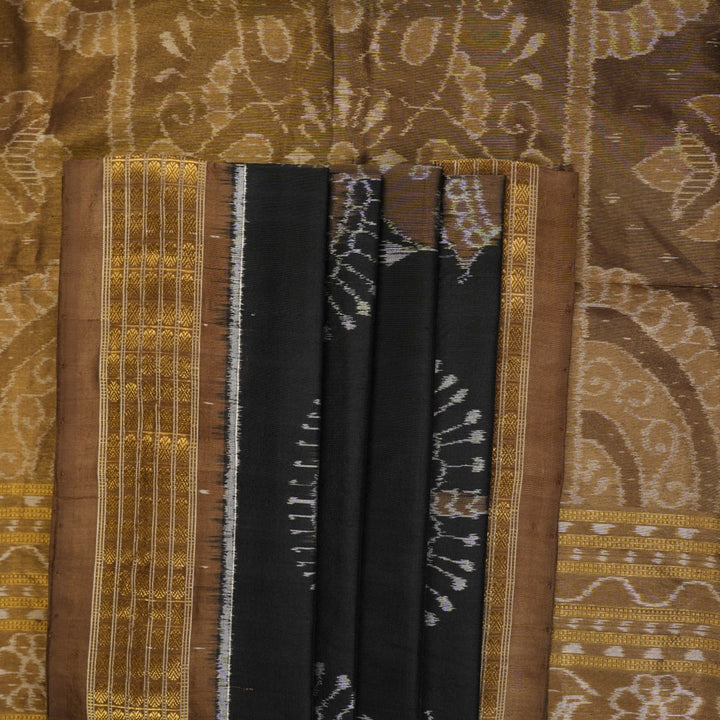 Close-up revealing the delicate, lustrous texture of the black silk tissue saree fabric with subtle sheen.