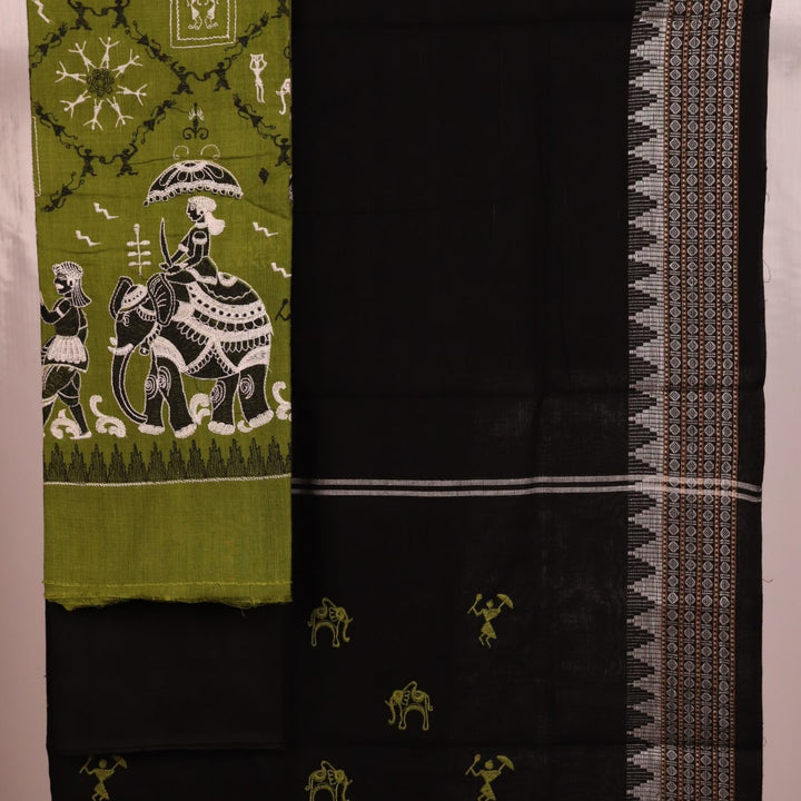 Close-up showcasing the Sambalpuri doll pattern on the green cotton dress material.