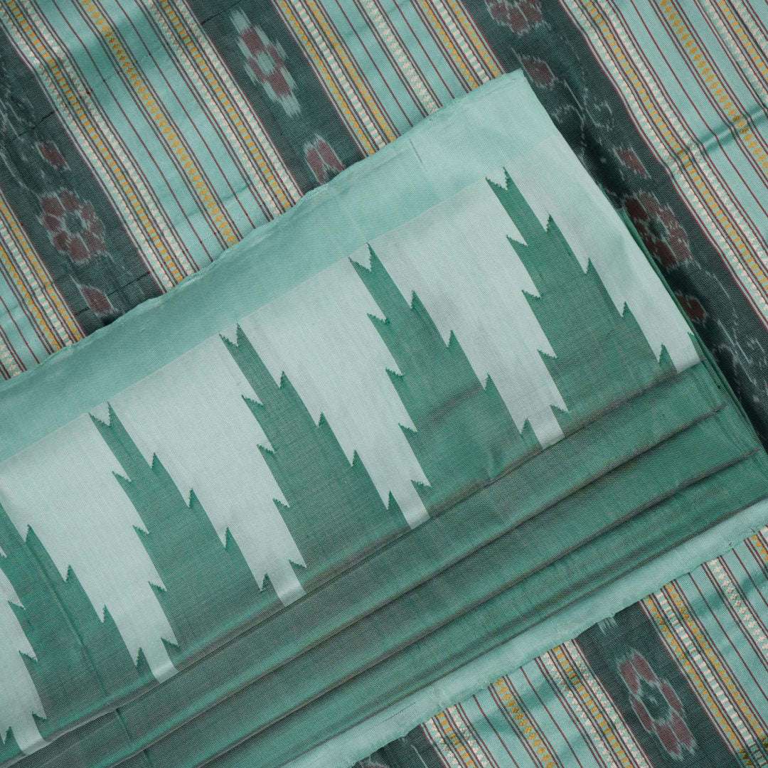 Extreme close-up of the green Sambalpuri silk fabric, revealing its luxurious texture and fine handloom weave.