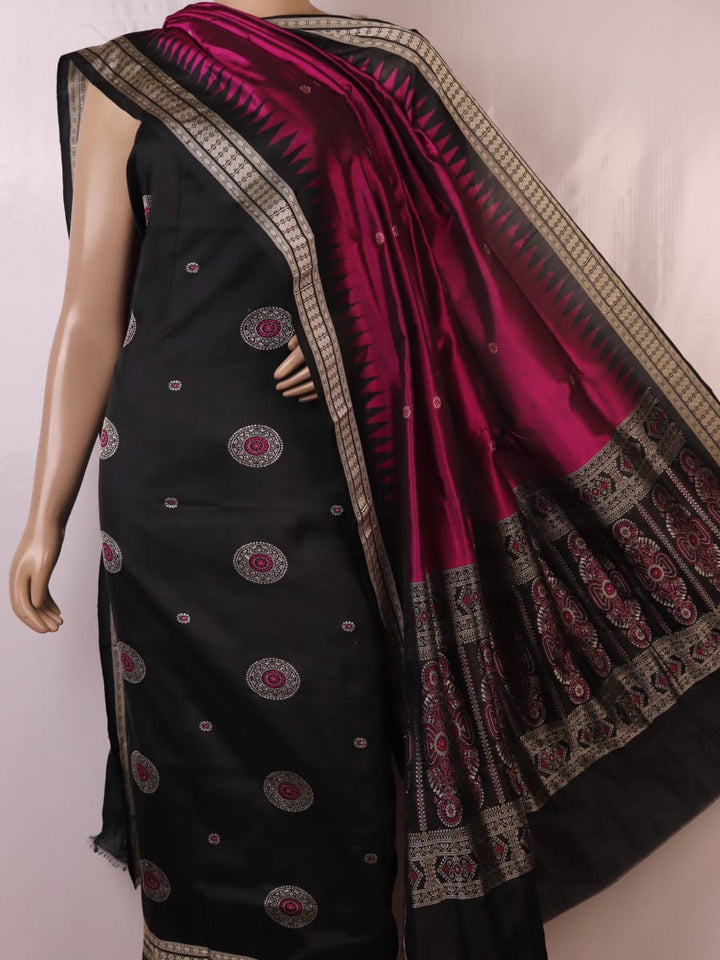 Close-up of Bomkai silk dress material blouse piece, black with magenta butta pattern.