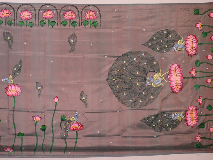 Close-up of hand-painted silk Patachitra saree fabric texture, showing the multicolor details and fine weave.