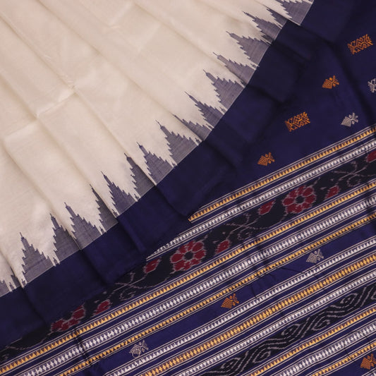 Close-up of white and blue Sambalpuri Silk Saree fabric texture, highlighting butta pattern.