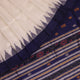 Close-up of white and blue Sambalpuri Silk Saree fabric texture, highlighting butta pattern.