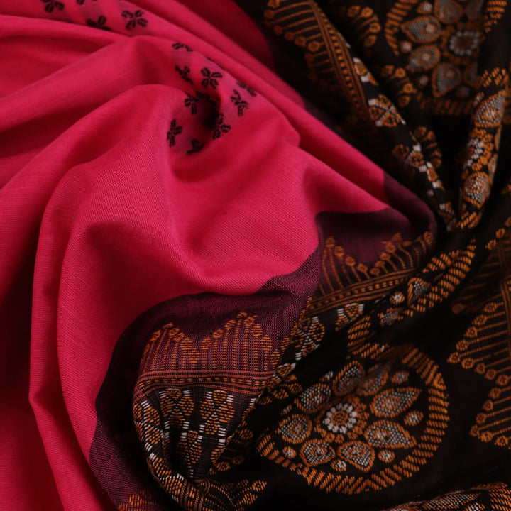 Full view of a pink and black cotton Bomkai saree with a Butta pattern.