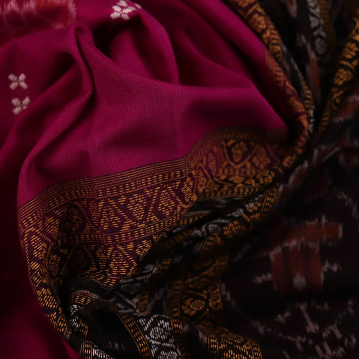 A full-length view of a vibrant magenta cotton Bomkai saree adorned with intricate black motifs.