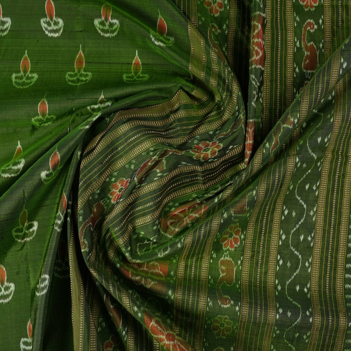 Ultra close-up of green Sambalpuri silk fabric, revealing its unique texture and fine weave.