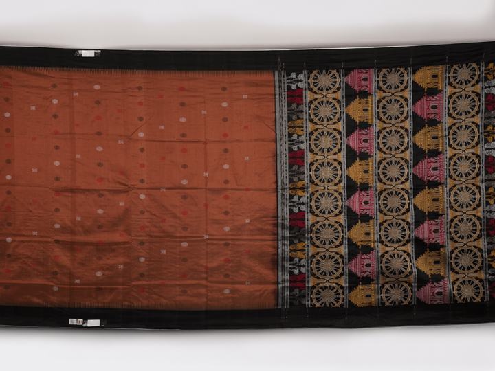 Extreme close-up of brown Bomkai silk saree fabric, revealing rich weave texture and luxurious feel.