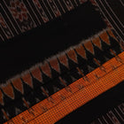 Woman draped in a yellow and black Sambalpuri cotton saree, showcasing the stylish drape and motif pattern.