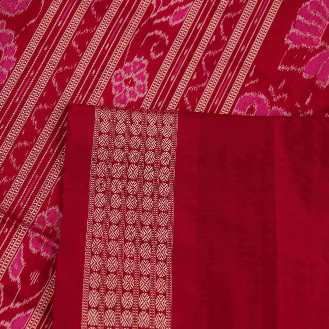 Close-up of intricate sambalpuri silk saree's yellow fabric featuring detailed motifs in rani color