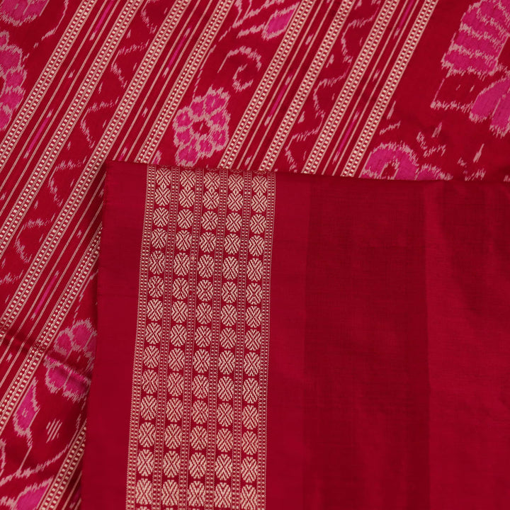 Close-up of intricate sambalpuri silk saree's yellow fabric featuring detailed motifs in rani color