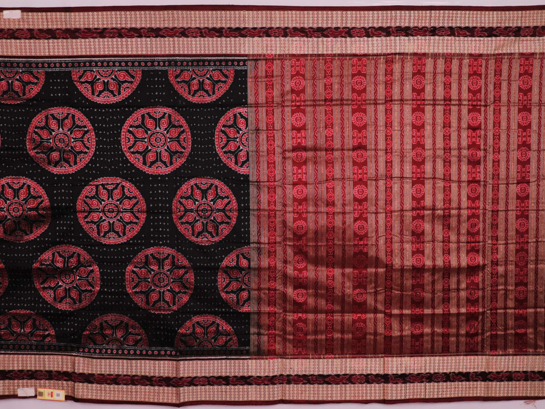 An approximately 150 cm wide handloom black silk Sambalpuri Saree with maroon motifs, captured in a close-up to depict its rich fabric texture.