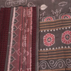 Close-up of a multicolored silk Sambalpuri saree fabric showing the intricate handloom texture and motifs.