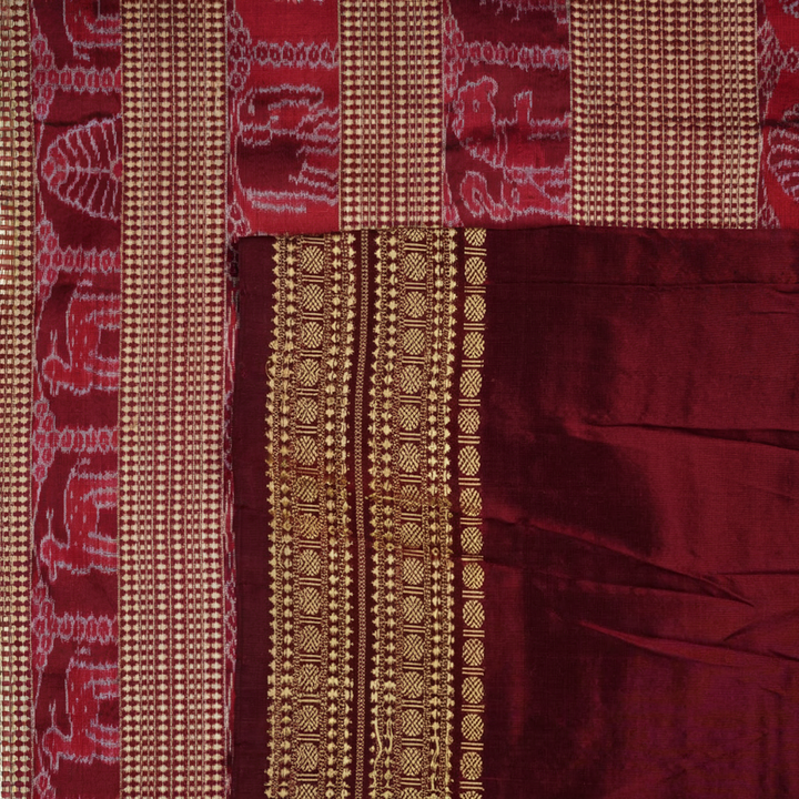 Close-up of the fine silk texture of the white Sambalpuri saree, highlighting its soft sheen and weave.