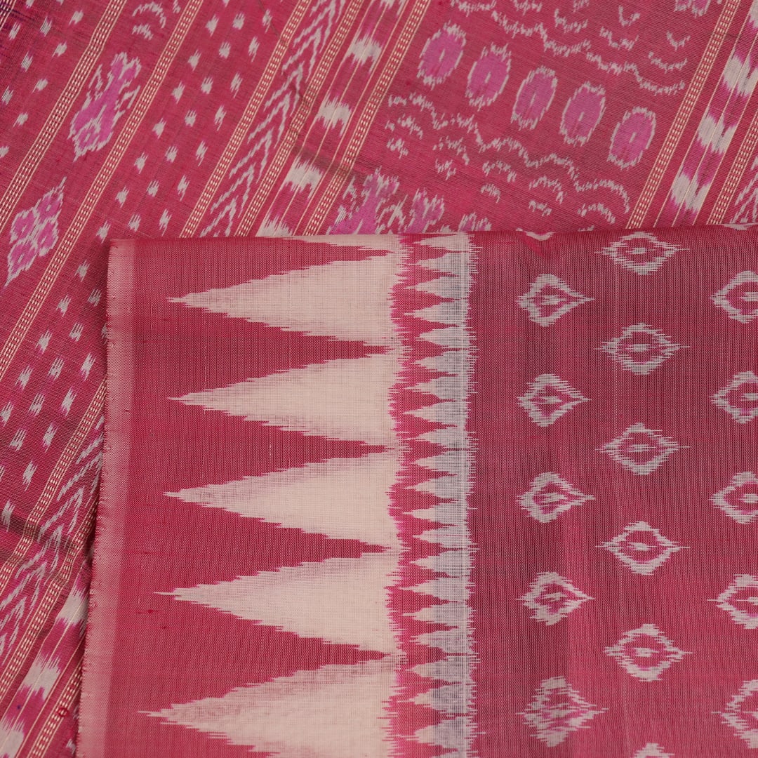 Close-up of soft, shimmering blue and peach silk fabric with intricate Sambalpuri motifs