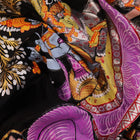 Close-up of black silk Patachitra saree fabric, showcasing hand-painted texture and detail.