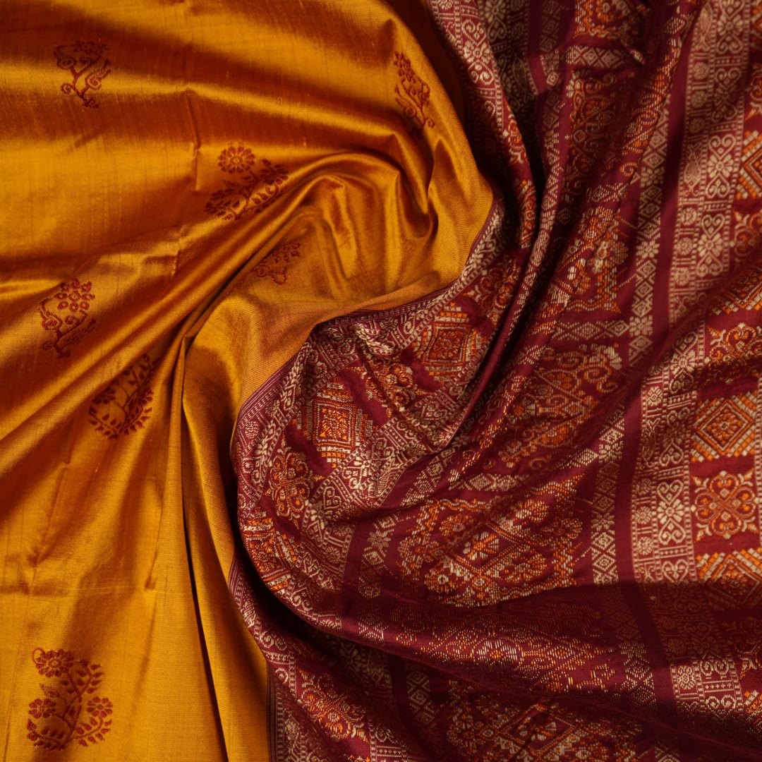 Ultra close-up of Bomkai silk saree fabric, revealing its luxurious texture and fine handloom weave.