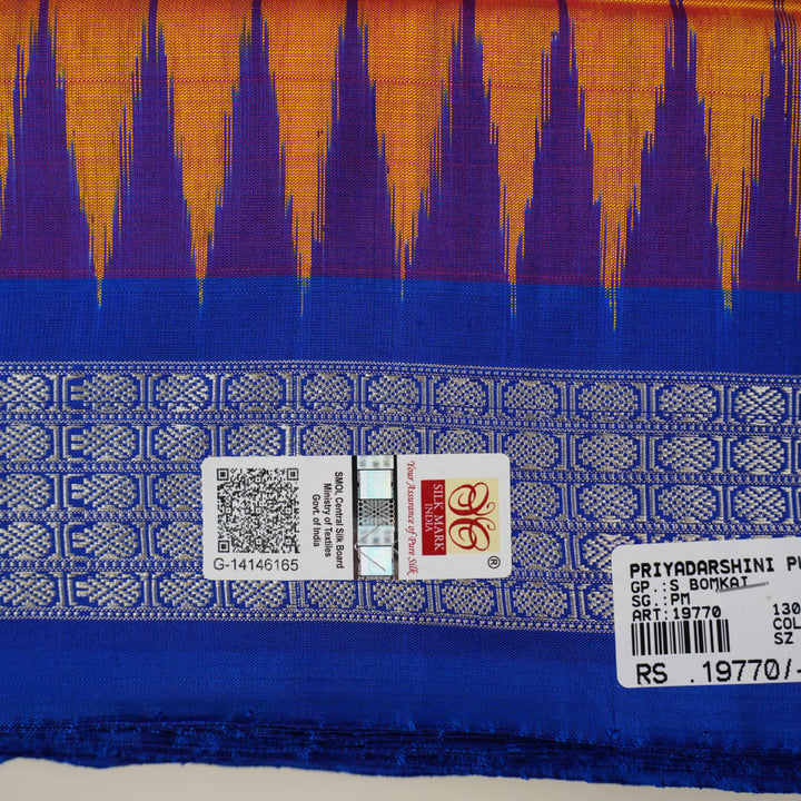 Close-up of Bomkai Silk Saree fabric texture and handloom weave in orange and blue threads.