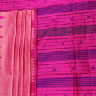 Close-up of plain peach and pink Sambalpuri silk saree fabric texture.
