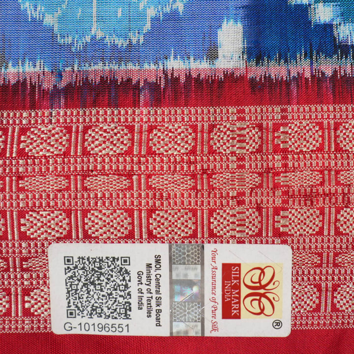Close-up of the luxurious silk fabric texture and distinctive Sambalpuri ikat weave of the blue Pasapalli saree.