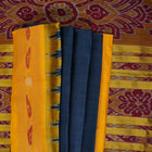 Model styling a blue and yellow Khandua silk saree with traditional butta work and border.