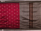 Close-up of magenta and black Bomkai silk saree texture, showing butta pattern weave.