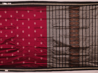 Close-up of magenta and black Bomkai silk saree texture, showing butta pattern weave.