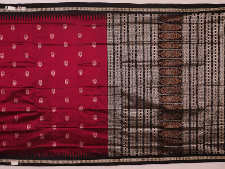 Close-up of magenta and black Bomkai silk saree texture, showing butta pattern weave.