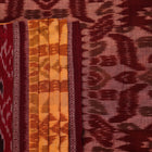 Yellow and maroon Sambalpuri cotton saree with motifs, draped elegantly to showcase its design.