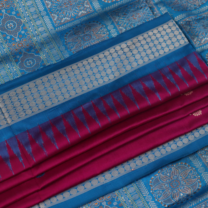 Close-up of Bomkai silk saree's textured weave, featuring magenta, blue, and butta pattern.