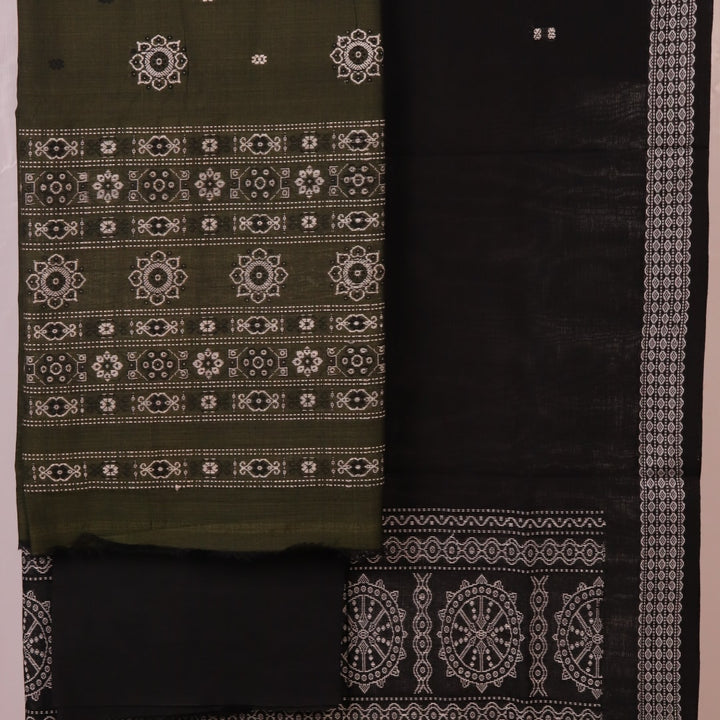 Detail of coordinating black Bomkai cotton blouse piece for green dress material.