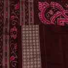 Close-up of peach and maroon Sambalpuri silk saree fabric showing intricate handloom texture and motifs.