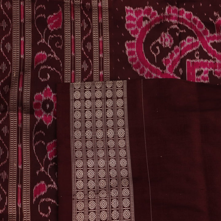 Close-up of peach and maroon Sambalpuri silk saree fabric showing intricate handloom texture and motifs.