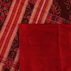 Close-up of plain green Sambalpuri silk saree fabric texture.