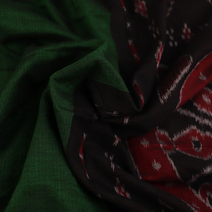 Green and black plain Sambalpuri cotton saree gracefully draped on a model, highlighting its elegant styling.