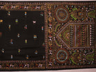 Close-up of the black silk Patachitra saree, showcasing the hand-painted fabric texture.